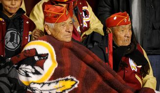 World War II Navajo code talkers stay warm along the sideline before being honored by the Redskins as the Washington Redskins play the San Francisco 49ers in Monday Night Football at FedExField, Landover, Md., Monday, November 25, 2013. (Andrew Harnik/The Washington Times)