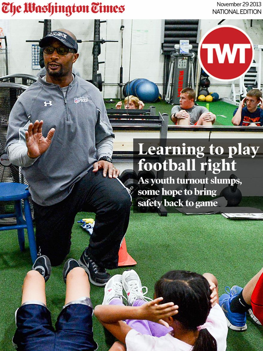 National Edition News Cover for November 29, 2013 - Learning to play football right: Former Washington Redskins linebacker Eddie Mason works young students at MASE Training, his football training facility, Sterling, Va., Thursday, November 21, 2013. With the concussion research that has come out recently in the last few years, Mason believes young children should be coached on the fundamentals of playing football without pads and full contact until they are at least 13 years old. (Andrew Harnik/The Washington Times)