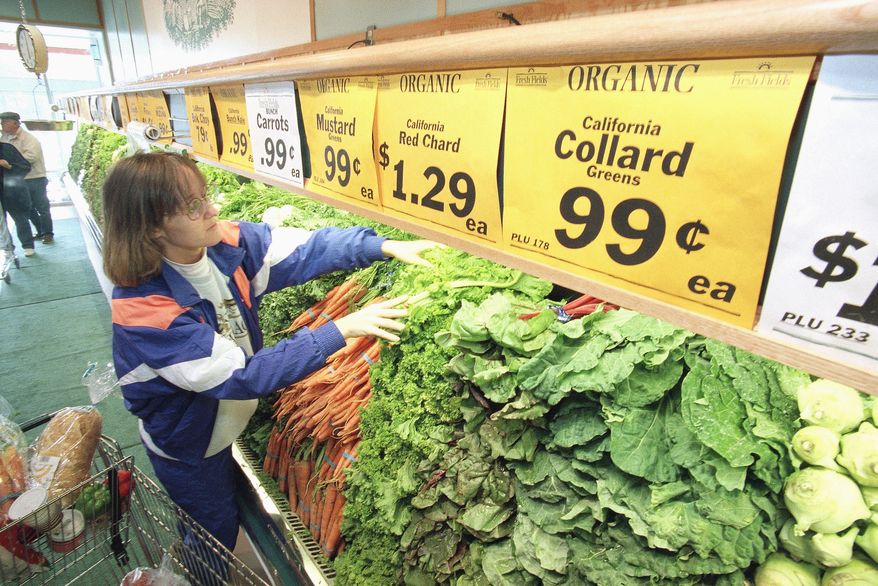 Kathy Weekman of Springfield, Va., checks organic produce at the Fresh Fields grocery store in Springfield, Va., Nov.13, 1993. Organic issues have vexed a panel helping the Agriculture Department to create nationwide standards for organic foods. In an age of biotechnology and international trade, the panel is dealing with more than compost and crop rotations, pesticide-free apples and carrots. (AP Photo/Greg Gibson)