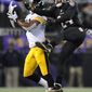 Baltimore Ravens cornerback Corey Graham, right, breaks up a pass attempt to Pittsburgh Steelers wide receiver Jerricho Cotchery in the second half of an NFL football game, Thursday, Nov. 28, 2013, in Baltimore. Baltimore won 22-20. (AP Photo/Gail Burton)