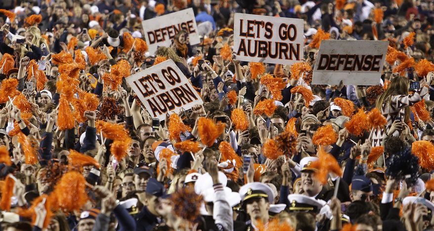 Auburn fans storm the field after their 34-28 a win over No. 1 Alabama in an NCAA college football game in Auburn, Ala., Saturday, Nov. 30, 2013. (AP Photo/Jay Sailors)
