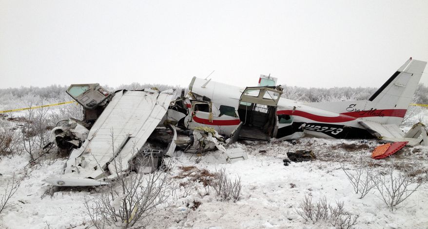The wreckage of a plane that crashed on Friday, Nov. 29, 2013, near St. Marys, Alaska, is pictured the next day. Authorities said the pilot and three passengers died when the single-engine turboprop Cessna 208 went down, but few other details, including the possible cause of the crash, are known. (AP Photo/Alaska State Troopers)