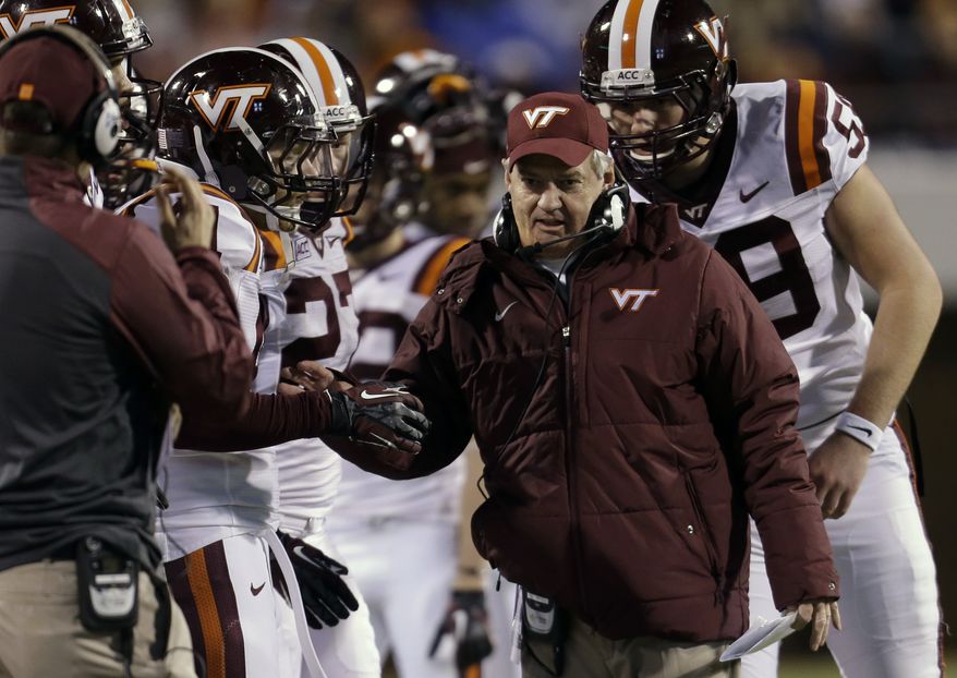 Virginia Tech head coach Frank Beamer talks to his team during the second half an NCAA college football game in Charlottesville, Va., Saturday, Nov. 30, 2013. Virginia Tech won the game 16-6. (AP Photo/Steve Helber)