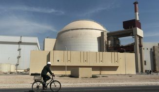 FILE - In this Oct. 26, 2010 file photo, a worker rides a bicycle in front of the reactor building of the Bushehr nuclear power plant, just outside the southern city of Bushehr, Iran. A report by Iran&#39;s official news agency quotes the country&#39;s nuclear chief, Ali Akbar Salehi, saying the Islamic Republic needs more nuclear power plants, just after it struck a deal regarding its contested nuclear program with world powers. Salehi said Iran is in serious talks with several countries including Russia to build four more nuclear power plants.(AP Photo/Mehr News Agency, Majid Asgaripour, File)