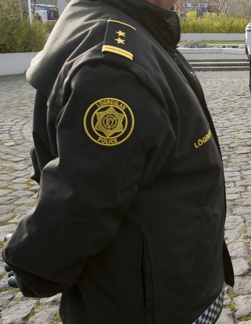 **FILE** Icelandic police officers attend a demonstration outside the Central Bank of Iceland on Oct. 10, 2008. (Associated Press)