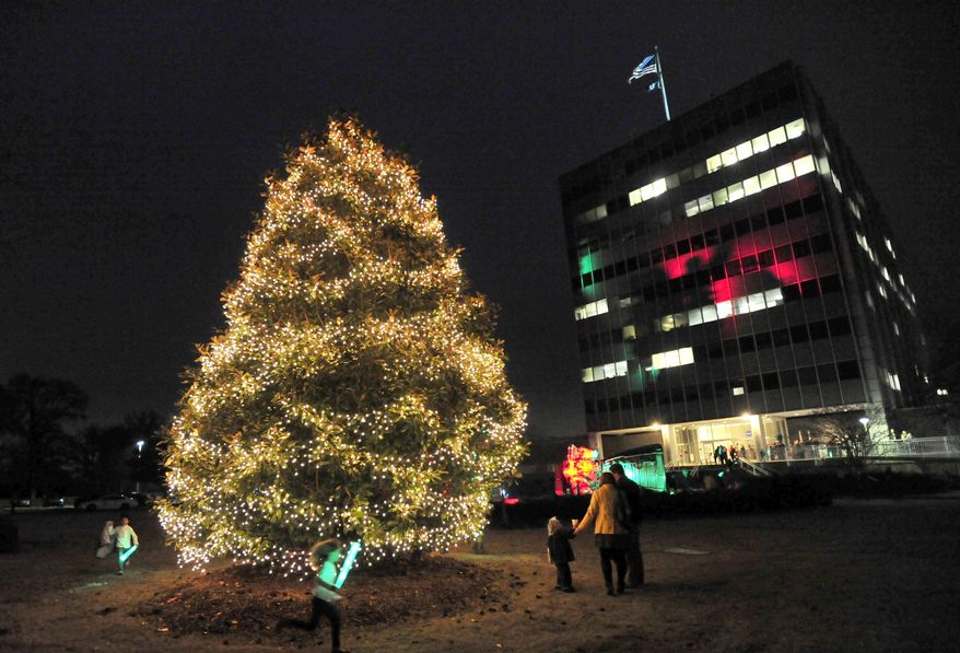A Christmas tree lit by Santa Claus illuminates the grounds at the Marshall Space Flight Center on Monday, Dec. 2, 2013, in Huntsville, Ala. (AP Photo/Eric Schultz, AL.com)