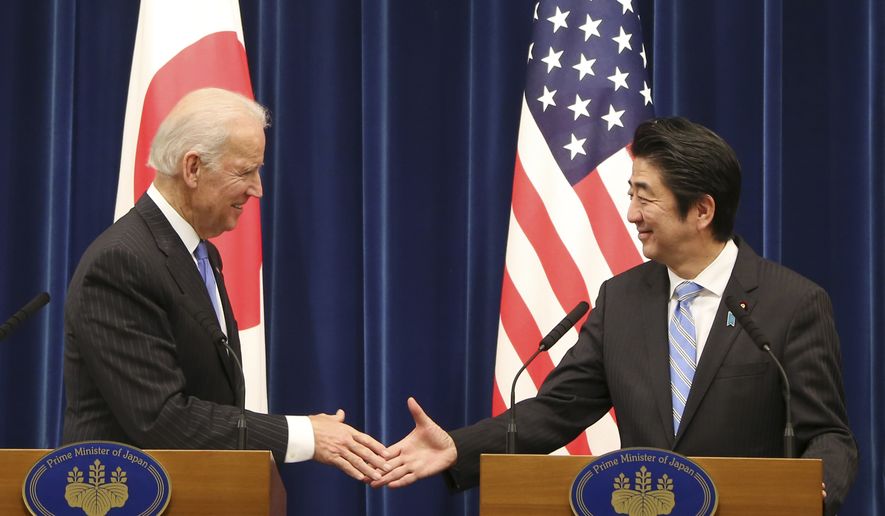 Then-U.S. Vice President Joe Biden shakes hands with Japanese Prime Minister Shinzo Abe at the end of a joint press conference following their meeting at Abe&#39;s official residence in Tokyo Tuesday, Dec. 3, 2013. (AP Photo/Koji Sasahara) ** FILE **
