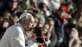 Pope Francis kisses a child as he arrives in St. Peter&#39;s Square for the weekly general audience at the Vatican, Wednesday, Dec. 4, 2013. (AP Photo/Gregorio Borgia)