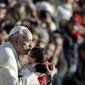 Pope Francis kisses a child as he arrives in St. Peter&#39;s Square for the weekly general audience at the Vatican, Wednesday, Dec. 4, 2013. (AP Photo/Gregorio Borgia)