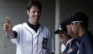 Detroit Tigers&#39; pitcher Doug Fister talks with teammates in the dugout about a pitch against the Los Angeles Angels in the sixth inning of a baseball game in Detroit, Thursday, June 27, 2013. (AP Photo/Paul Sancya)