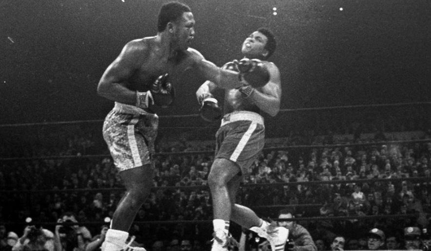 Joe Frazier hits Muhammad Ali with a left during the 15th round of their heavyweight title fight at New York&#x27;s Madison Square garden in this March 8, 1971 photo. (AP Photo/stf)