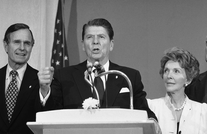 Presidential hopeful Ronald Reagan, center, is flaked by his wife Nancy, and former opponent George Bush, as he delivers a speech at a reception in the New York Hotel Pierre on Monday, June 17, 1980 in New York. Reagan was in New York to meet with editorial boards and to continue his efforts to help his former Republican opponent pay off their campaign debts. (AP Photo/Lederhandler)