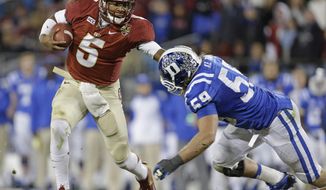 Florida State&#39;s Jameis Winston (5) scrambles as Duke&#39;s Kelby Brown (59) defends in the first half of the Atlantic Coast Conference Championship NCAA football game in Charlotte, N.C., Saturday, Dec. 7, 2013. (AP Photo/Bob Leverone)