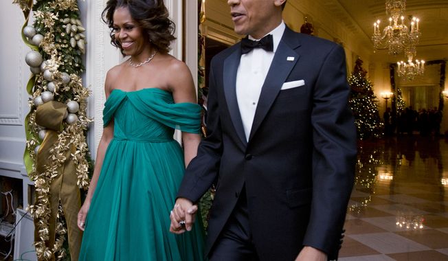Host President Barack Obama and first lady Michelle Obama, arrive at the 2013 Kennedy Center Honors reception honoring the 2013 Kennedy Center Honors recipients, in the East Room of the White House in Washington, Sunday, Dec. 8, 2013.  (AP Photo/Manuel Balce Ceneta)