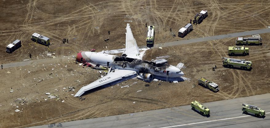 ** FILE ** In this Saturday, July 6, 2013, aerial photo, the wreckage of the Asiana Flight 214 airplane is seen after it crashed at the San Francisco International Airport in San Francisco, Saturday, July 6, 2013. (AP Photo/Marcio Jose Sanchez)