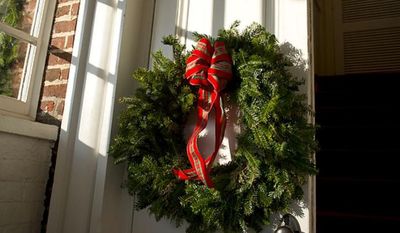 A wreath hangs on the door of Christ Church in Alexandria on Sunday, Dec. 18, 2011. (Rod Lamkey Jr./The Washington Times)