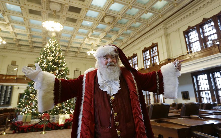 Bill French, dressed as Santa Claus, visits the House floor following a news conference at the state capitol, Monday, Dec. 9, 2013, in Austin , Texas. French was helping Rep. Bohac to raise awareness for the Texas' new Merry Christmas law that allows teachers, students, parents and school administrators to celebrate traditional winter holidays like Christmas and Hanukah in public schools without fear of censorship, persecution, or litigation. (AP Photo/Eric Gay)