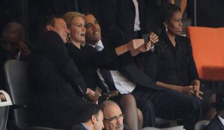Selfie: President Obama gets some assistance from Danish Prime Minister Helle Thorning-Schmidt holding a smartphone to pose for a picture with British Prime Minister David Cameron. First lady Michelle Obama clearly stayed away from the antics. (Agence France-Presse/Getty Images)