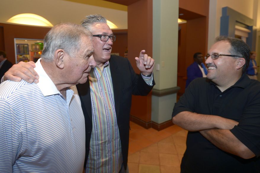 Former Atlanta Braves manager Bobby Cox, left, Pittsburgh Pirates manager Clint Hurdle, center, and former Orlando Magic head basketball coach Stan Van Gundy share a laugh at Baseball's winter meetings in Lake Buena Vista, Fla., Tuesday, Dec. 10, 2013. Cox was elected to the Hall of Fame on Monday. (AP Photo/Phelan M. Ebenhack)