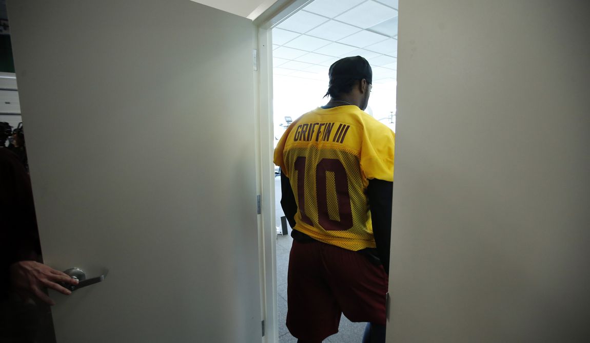 Washington Redskins quarterback Robert Griffin III, departs after speaking during a media availability at their NFL football training facility, Wednesday, Dec. 11, 2013, in Ashburn, Va. Kirk Cousins will start for the Redskins on Sunday, and Griffin III will be the No. 3 quarterback behind Rex Grossman. (AP Photo/Alex Brandon)