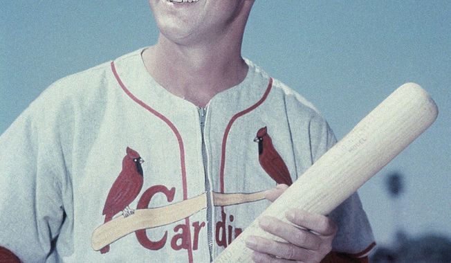 FOR USE AS DESIRED, YEAR END PHOTOS - FILE - In this March 1958 file photo, St. Louis Cardinals&#x27; Stan Musial, with bat in hand, poses for a photo during spring training baseball in Florida. Musial, one of baseball&#x27;s greatest hitters and a Hall of Famer with the Cardinals for more than two decades, died Saturday, Jan. 19, 2013. He was 92. (AP Photo/File)