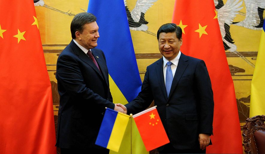 Ukrainian President Viktor Yanukovych shakes hands with Chinese President Xi Jinping during a signing ceremony at the Great Hall of the People in Beijing last week. Mr. Yanukovych&#39;s visit is aimed at gaining Chinese support for Ukraine&#39;s battered economy. The country&#39;s economic malaise has helped fuel ongoing protests in Kiev. (ASSOCIATED PRESS)