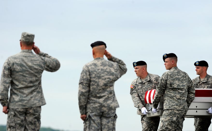 An Army carry team moves a transfer case containing the remains of Sgt. Stefan M. Smith Thursday, July 25, 2013 at Dover Air Force Base, Del. According to the Department of Defense, Smith, 24, of Glennville, Ga., died July 23, 2013 when his unit was attacked with an improvised explosive device in Afghanistan. (AP Photo/Steve Ruark)