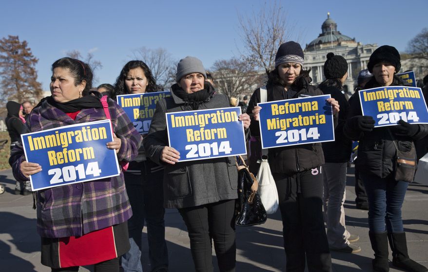 ** FILE ** Immigration activists gather on Capitol Hill in Washington, Thursday, Dec. 12, 2013, as lawmakers speak on the steps of the House of Representatives to appeal for action on an immigration reform bill. A reform bill that could provide a pathway to citizenship for the roughly 11 million immigrants living illegally in the United States has languished as the House Republican leadership has not put the bill to a vote before the holiday recess. (AP Photo/J. Scott Applewhite)