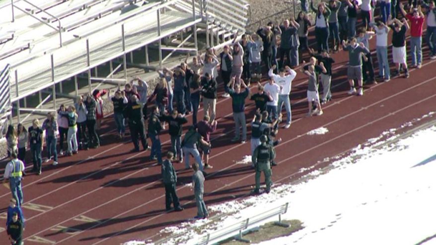 In this still image taken from video provided by Fox 31 Denver, students gather just outside of Arapahoe High School as police respond to reports of a shooting at Arapahoe High School in Centennial, Colo. Friday, Dec. 13, 2013. Colorado division of emergency management spokeswoman Micki Trost said her director went to the school and their weren't any more immediate details. (AP Photo/KDVR) MANDATORY CREDIT