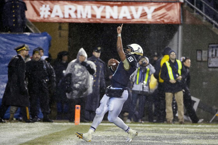 Navy quarterback Keenan Reynolds (19) gestures after scoring a touchdown during the second half of an NCAA college football game against Army, Saturday, Dec. 14, 2013, in Philadelphia. Navy won 34-7. (AP Photo/Matt Slocum)