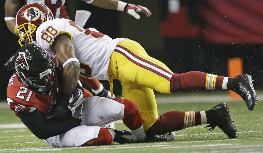 Atlanta Falcons cornerback Desmond Trufant (21) comes up with an interception as Washington Redskins wide receiver Pierre Garcon (88) defends during the second half of an NFL football game, Sunday, Dec. 15, 2013, in Atlanta. (AP Photo/John Bazemore)