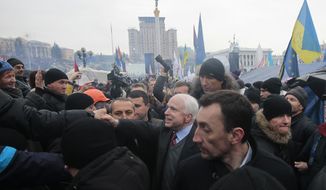 Sen. John McCain (center) greets well-wishers as he arrives to visit a pro-European Union rally in Independence Square in Kiev on Sunday, Dec. 15, 2013. About 200,000 anti-government demonstrators converged on the central square of Ukraine&#39;s capital in a dramatic demonstration that the opposition&#39;s morale remains strong after nearly four weeks of daily protests. (AP Photo/Sergei Chuzavkov)