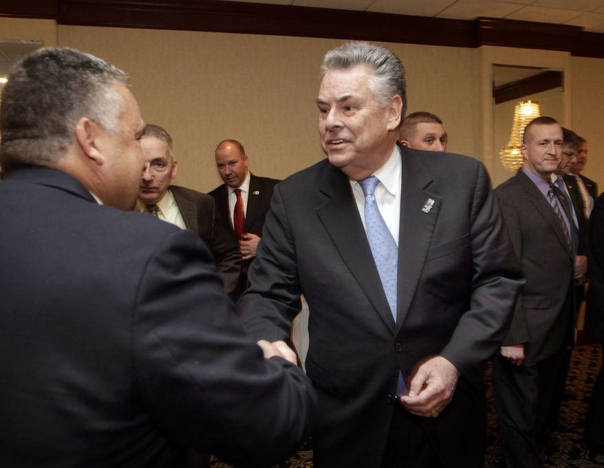 U.S. Rep. Peter King, R-N.Y., right, shakes hands with members of the Northeast Regional Troopers Coalition, Monday, Dec. 16, 2013 in Concord, N.H. King is considered a possible presidential candidate for 2016. (AP Photo/Jim Cole)