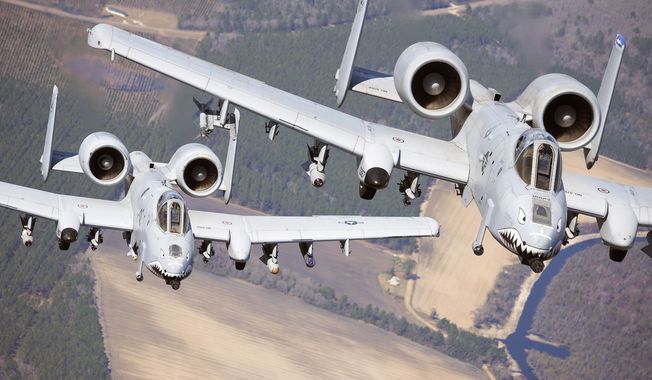 Two A-10C Thunderbolt II aircraft pilots fly in formation during a training exercise March 16, 2010, at Moody Air Force, Ga. Members of the 74th Fighter Squadron performed surge operations to push its support function to the limit and simulate pilots&#x27; wartime flying rates. (U.S. Air Force photo by Airman 1st Class Benjamin Wiseman) **FILE**