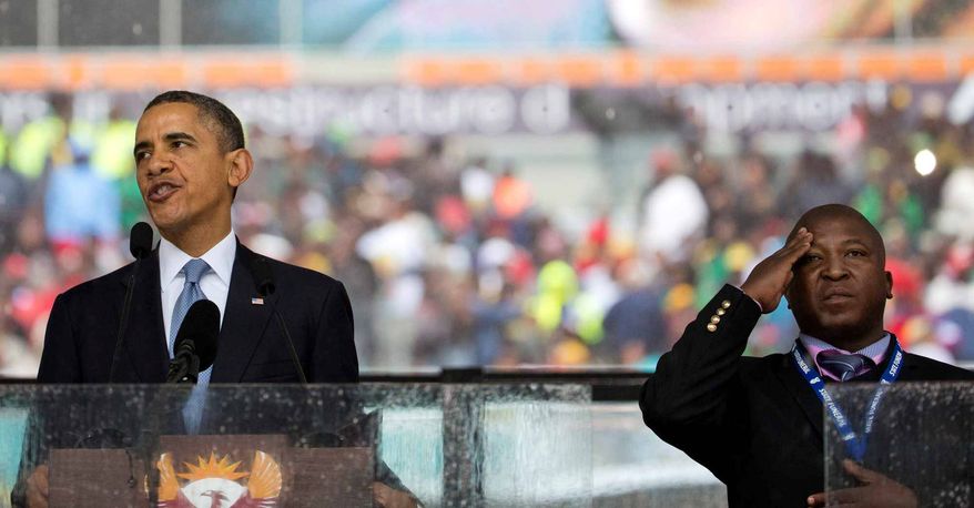 President Obama and sign-language translator Thamsanqa Jantjie during the Nelson Mandela memorial service last week. Associated Press