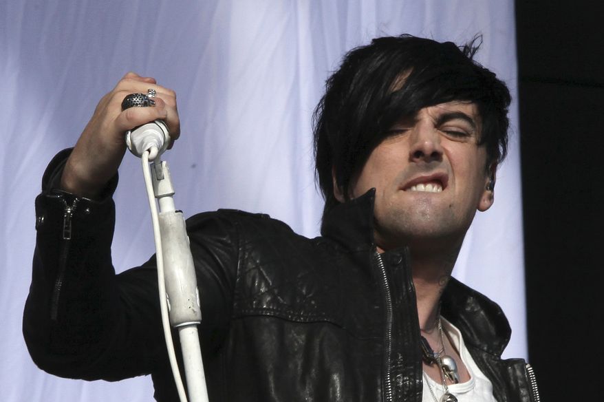 FILE - This is a Saturday, Aug 20, 2011 file photo of British musician Ian Watkins, lead singer of Lostprophets, as he performs on stage at V Music Festival in Hylands Park, Chelmsford, England. A British judge on Wednesday, Dec. 18 2013, has jailed the former lead singer of rock band Lostprophets for 29 years for a string of sexual offenses, including trying to rape a baby. Ian Watkins, 36, pleaded guilty last month to 13 charges which included sexually touching a 1-year-old, encouraging a fan to abuse her child and making child pornography. (AP Photo / Joel Ryan, File)