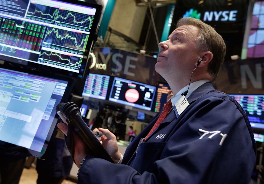 Trader F. Hill Creekmore works on the floor of the New York Stock Exchange Wednesday, Dec. 18, 2013. Stocks surged after the Federal Reserve decided the U.S. economy was strong enough for it to reduce its stimulus efforts. (AP Photo/Richard Drew)