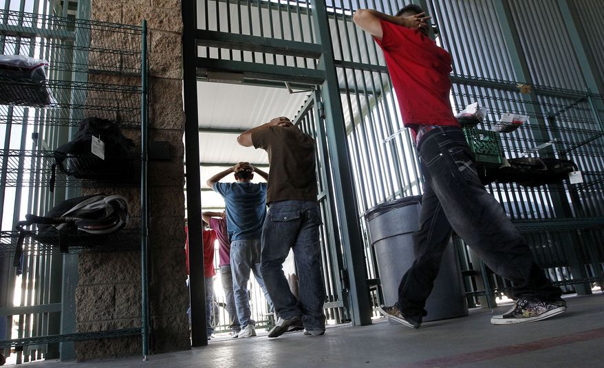 ** FILE ** Illegal immigrants prepare to enter a bus after being processed at Tucson Sector U.S. Border Patrol Headquarters Thursday, Aug. 9, 2012, in Tucson, Ariz. New strategies being implemented by the U.S. government, including the halting of one-way flights back to the interior cities in Mexico, are in place to streamline processing and expedite a return to Mexico. (AP Photo/Ross D. Franklin)