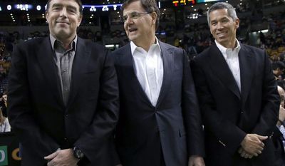 In this photo taken on Dec. 18, 2013, Boston Celtics managing partner Wyc Grousbeck, left, stands with venture capitalist Bob Higgins, center, and team co-owner Mark Wan, right, during a break in the action at an NBA basketball game in Boston. Grousbeck and a group featuring a dozen of his co-owners in the NBA franchise have invested $21 million into Formula E, an all-electric auto racing series that has already attracted interest from environmental celebrities like Leonardo DiCaprio and Richard Branson. The circuit is scheduled to debut in Beijing in September and continue on the streets from Miami to Monaco in a 10-race, Formula One-style championship. (AP Photo/Elise Amendola)