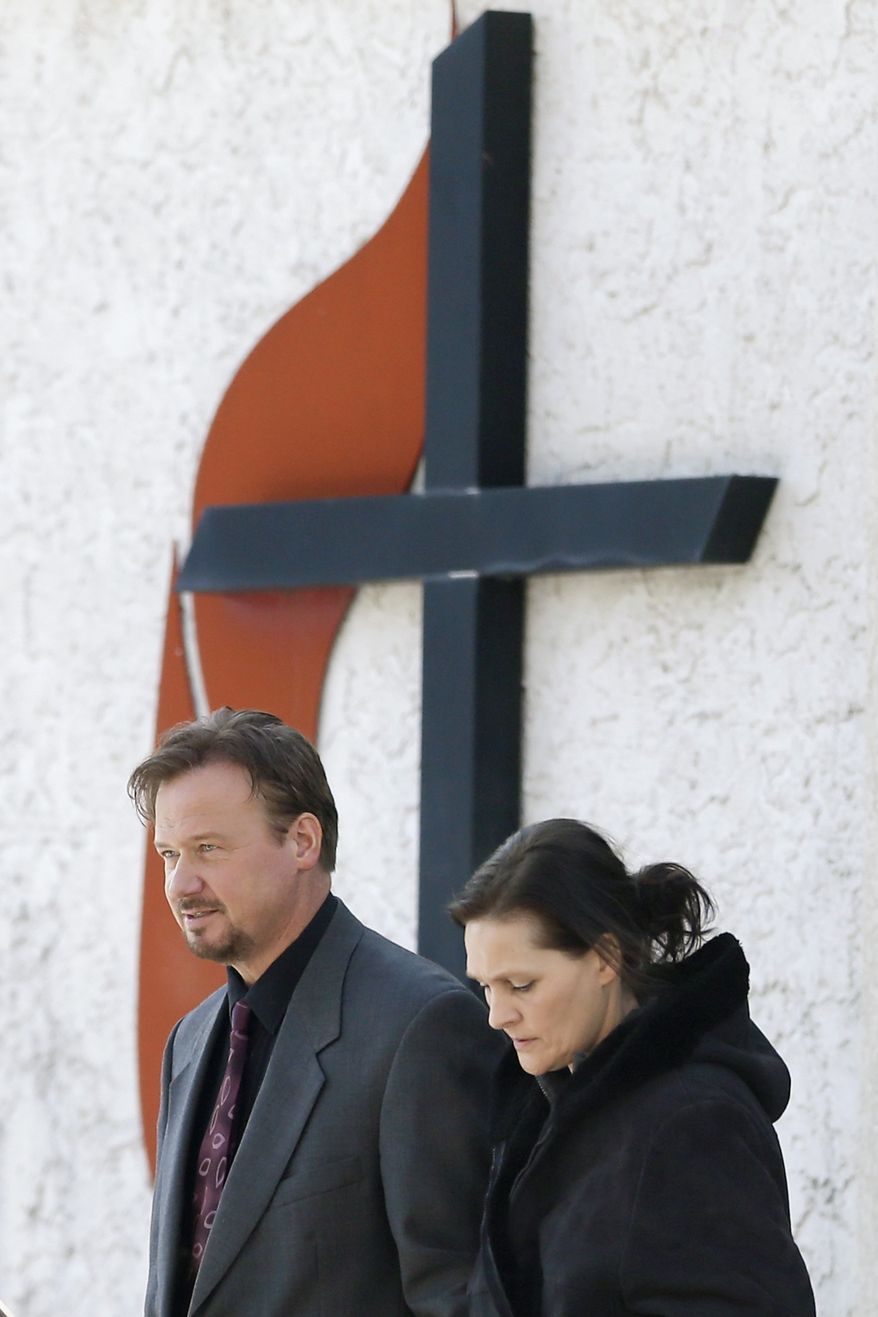 Accompanied by his wife Brigitte, right, the Rev. Frank Schaefer, of Lebanon, Pa., departs after a meeting with officials at the Eastern Pennsylvania Conference of the United Methodist Church, Thursday, Dec. 19, 2013, in Norristown, Pa. Church officials have defrocked Schaefer, who officiated his son's gay wedding in Massachusetts. (AP Photo/Matt Rourke)
