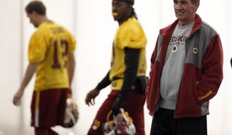 FILE - In this Dec. 11, 2013 file photo, Washington Redskins quarterbacks Kirk Cousins, left, and Robert Griffin III, center, walk behind head coach Mike Shanahan, during their NFL football practice Wednesday, Dec. 11, 2013, in Ashburn, Va.  If these are indeed Mike Shanahan&#39;s final days with the Washington Redskins, his legacy will be one of an inability to make things work with his quarterbacks, from Donovan McNabb to Rex Grossman to John Beck to Robert Griffin III.  (AP Photo/Alex Brandon)