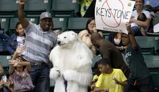 A person dressed as a polar bear and others demonstrate against the Keystone Pipeline as President Barack Obama and the first family attend the Oregon State University versus University of Akron college basketball game at the Diamond Head Classic at the Stan Sheriff Center in Honolulu, Sunday, Dec. 22, 2013. Michelle Obama&#39;s bother, Craig Robinson, is the coach for Oregon State. The first family is in Hawaii for their annual holiday vacation. (AP Photo/Carolyn Kaster)