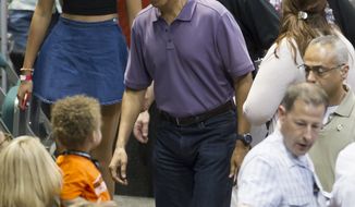 President Obama (center), and his daughter, Malia (left), arrive at the Stan Sheriff Center before the start of the Oregon State-Akron NCAA college basketball game at the Diamond Head Classic in Honolulu on Dec. 22, 2013. The President&#x27;s brother-in-law Craig Robinson is the head coach of Oregon State. (Associated Press)
