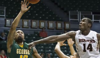 Oregon State forward Daniel Gomis (14) attempts to block a shot byGeorge Mason guard Sherrod Wright (10) during the first half of an NCAA college basketball game at the Diamond Head Classic on Monday, Dec. 23, 2013, in Honolulu. (AP Photo/Eugene Tanner)