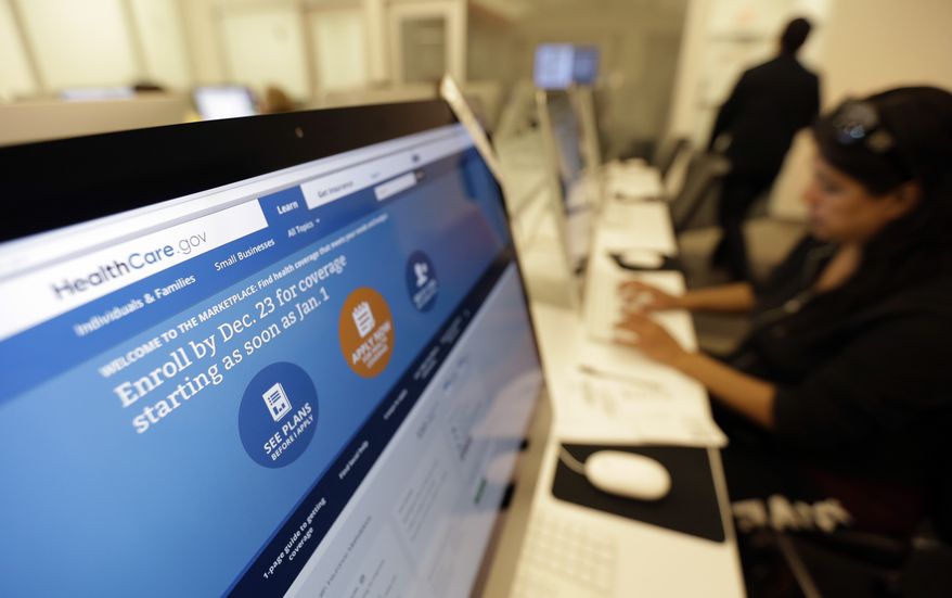** FILE ** In this Wednesday, Dec. 11, 2013, file photo, Rosemary Cabelo uses a computer at a public library to access the Affordable Health Care Act website, in San Antonio. (AP Photo/Eric Gay, File)