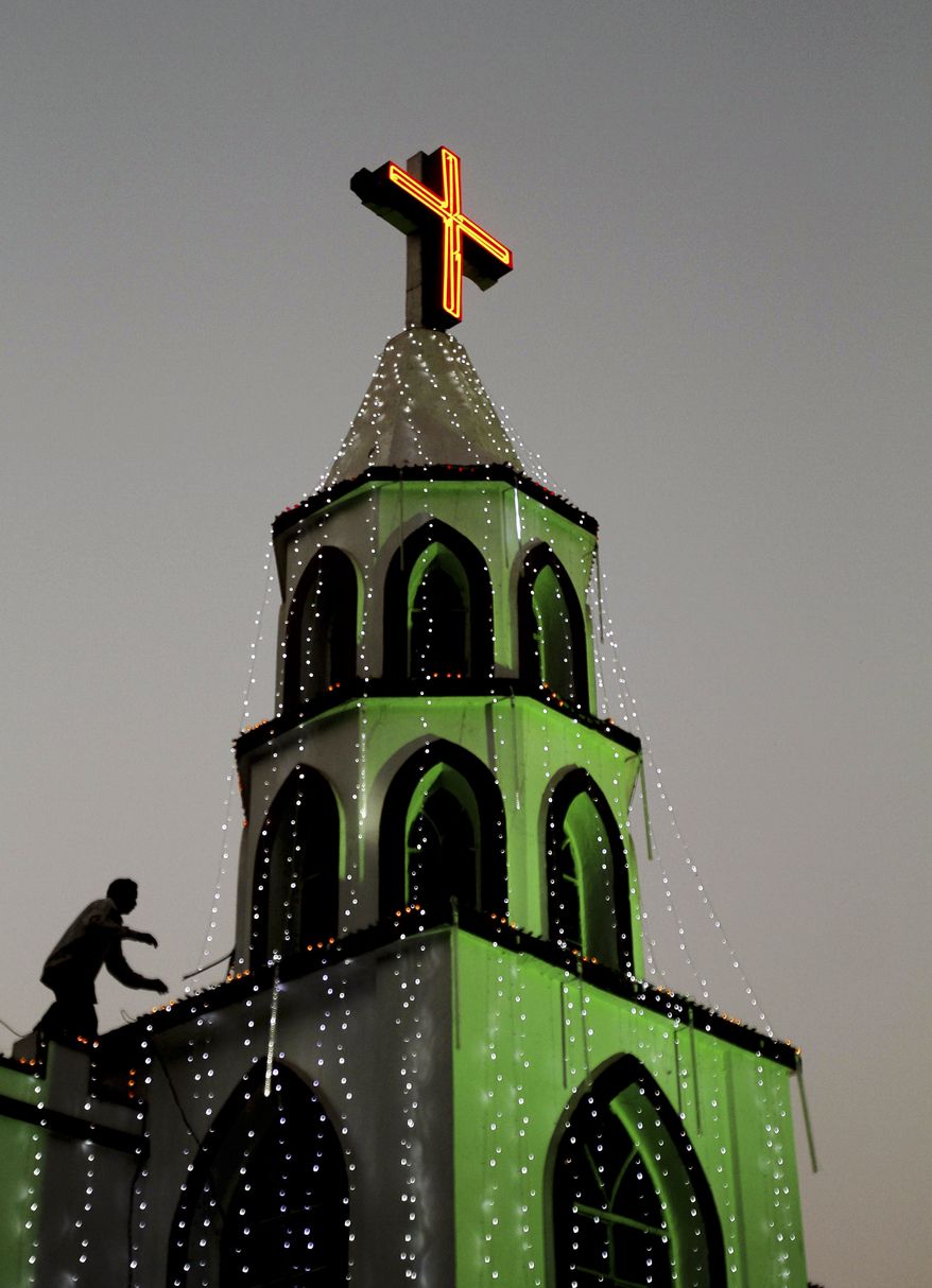 An Indian man decorates a church with lights ahead of Christmas in the eastern Indian city of Bhubaneswar, India, Monday, Dec. 23, 2013. Although Christians comprise only two percent of the population, Christmas is a national holiday and is observed across the country as an occasion to celebrate. (AP Photo/Biswaranjan Rout)