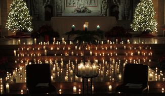Dozens of candles adorn the alter during a Blue Christmas service at the Christ Church Cathedral, Monday, Dec. 23, 2013, in St. Louis. The solemn ceremony is for people who are sad or depressed during the holiday season. (AP Photo/Tom Gannam)