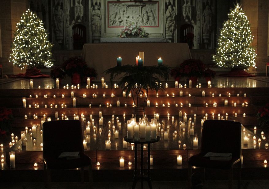 Dozens of candles adorn the alter during a Blue Christmas service at the Christ Church Cathedral, Monday, Dec. 23, 2013, in St. Louis. The solemn ceremony is for people who are sad or depressed during the holiday season. (AP Photo/Tom Gannam)