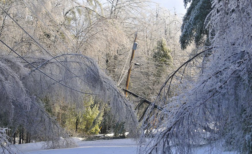 ** FILE ** Trees frozen in ice cripple a section of power lines on Maplehurst Drive in Belgrade, Maine, Tuesday, Dec. 24, 2013. From Michigan to Maine, hundreds of thousands remain without power days after a massive ice storm — which one utility called the largest Christmas-week storm in its history — blacked out homes and businesses in the Great Lakes and Northeast. (AP Photo/The Central Maine Morning Sentinel, Michael G. Seamans)