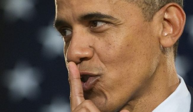 President Obama signals quiet during a speaking appearance.